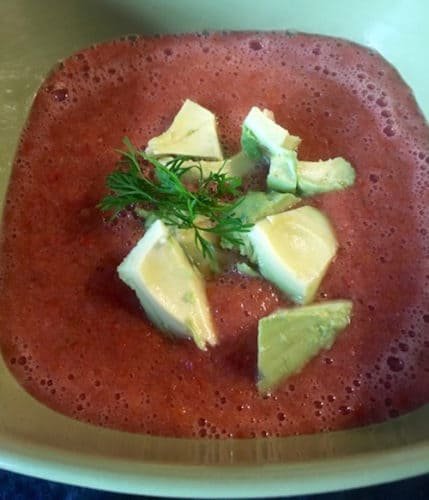 Gazpacho garnished with avocado and cilantro