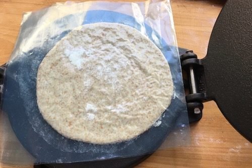 Dough round in its trimmed zipper bag, after the second press