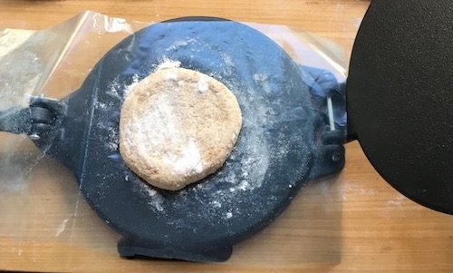 Dough round in its zipper bag, ready to be pressed